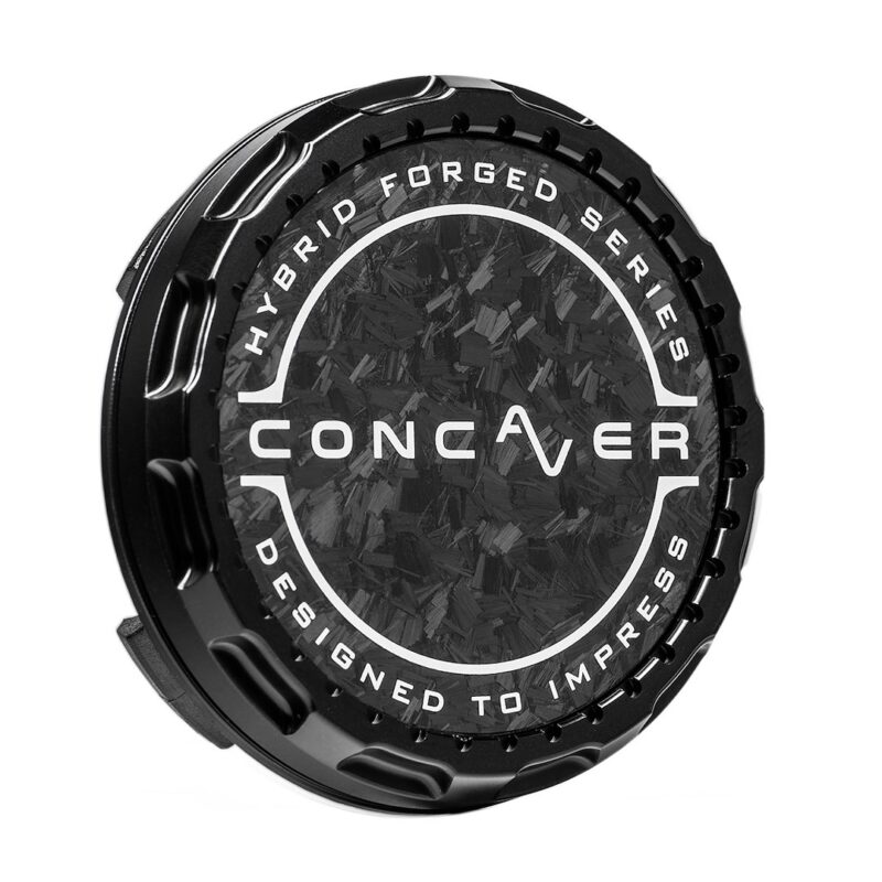 Black circular car wheel center cap with a textured carbon‑fiber pattern and white branding reading CONCAVER, HYBRID FORGED SERIES, DESIGNED TO IMPRESS