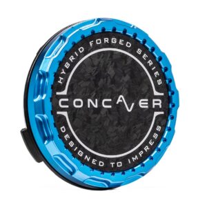 Blue metallic circular device with a textured black center and white ring text reading 'Hybrid Forged Series' and 'Designed to Impress' around the edge, with 'Conquer' branding in the middle.