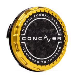 Gold circular car wheel center cap with black textured center, featuring the word CONCAVER and the edge text 'Designed to Impress'.