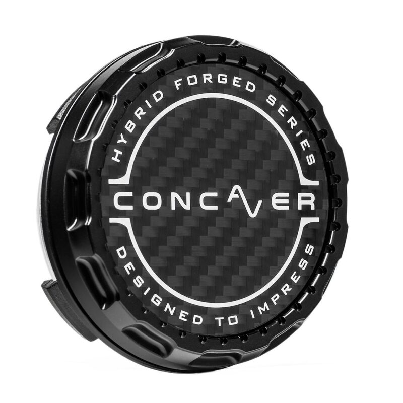 Round black cap with carbon-fiber center and white ring text reading 'HYBRID FORGED SERIES' around top and 'DESIGNED TO IMPRESS' around bottom, with 'CONCAVER' centered.