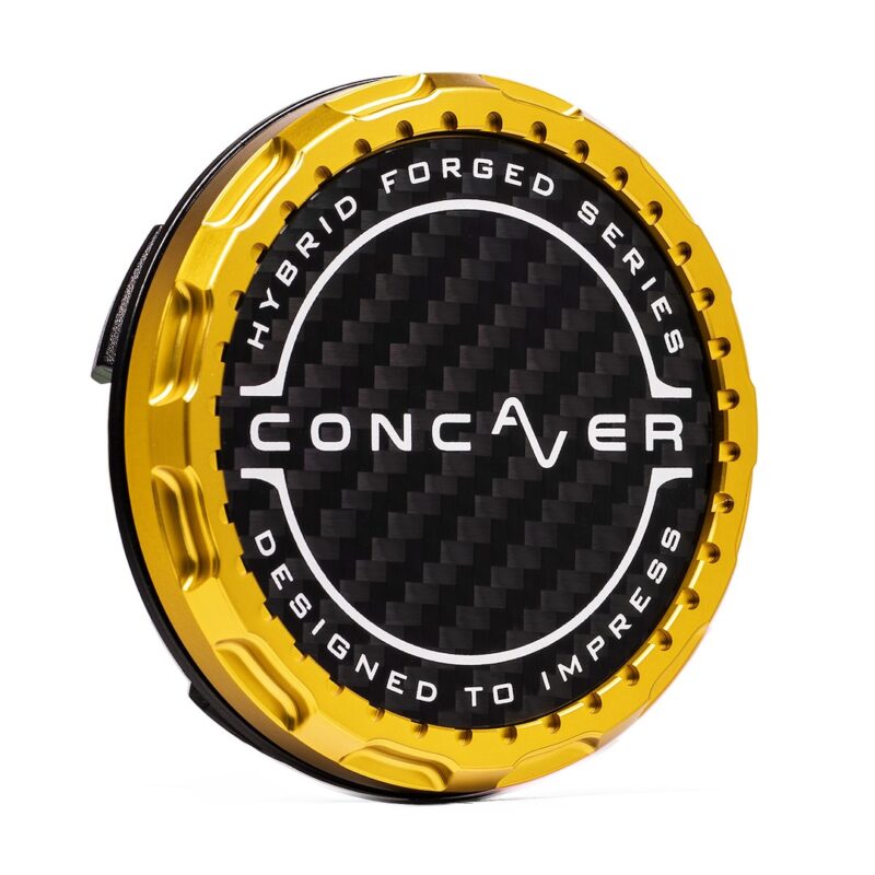 Gold circular alloy wheel center cap with a carbon fiber face and the words 'Hybrid Forged Series' around the rim, branding 'Conver' in the center (car part)