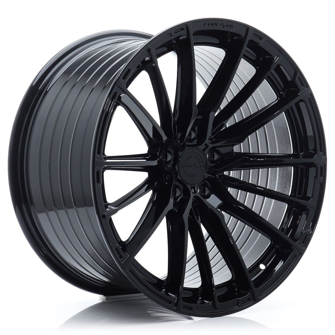 53071_0_39047jpg - OPSHOLDERS Glossy black alloy car wheel with a multi-spoke design, shown at an angle to highlight the rim.