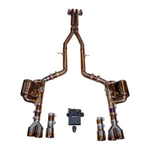 Copper-toned automotive exhaust system sculpture arranged as a standing figure with arms raised, made from twin pipes and exhaust tips.