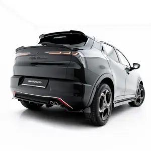 Rear three-quarter view of a glossy black SUV with a sporty rear spoiler, angular taillights, and a '#MAXTONIZED' license plate.