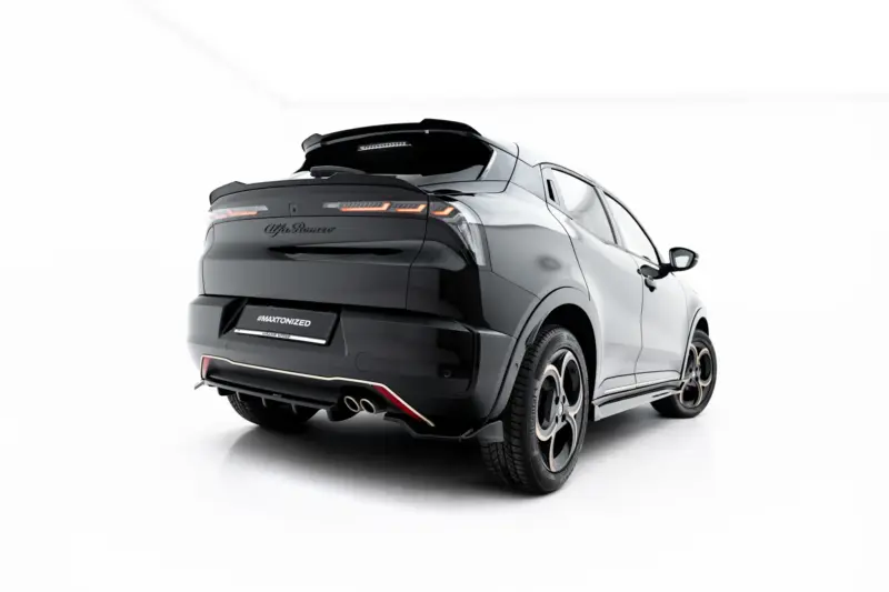 Rear three-quarter view of a glossy black SUV with a sporty rear spoiler, angular taillights, and a '#MAXTONIZED' license plate.