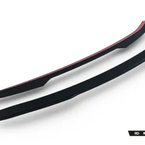Pair of sleek black curved car side skirts with a red accent stripe, displayed diagonally on a white background; Maxton Design branding visible in the corner.