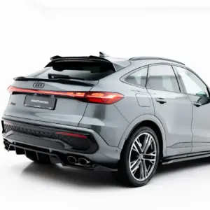 Rear three-quarter view of a silver Audi SUV with illuminated taillights and large alloy wheels, set against a white background.