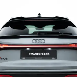 Rear view of a silver Audi SQ5 with red taillights and the license plate reading #MAXTONIZED, showing the Audi rings logo.