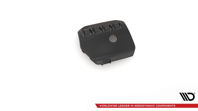 Black textured automotive component featuring four vent openings and a circular raised area, shown at an oblique angle on a white background.