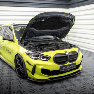 Bright lime-yellow BMW sports sedan with its hood open, exposing the engine in a showroom setting.