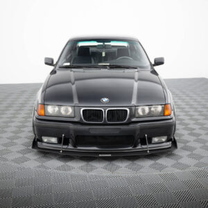 Front view of a dark gray BMW SUV in a studio with a checkered floor.