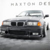 pol_po_FRONT-RACING-SPLITTER-BMW-M3-3-M-Pack-Coupe-Cabrio-E36-1813_3jpg - OPSHOLDERS Front view of a dark gray BMW sedan in a showroom with Maxton Design branding in the background