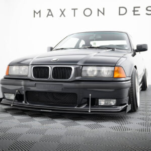 Front view of a dark gray BMW sedan in a showroom with Maxton Design branding in the background