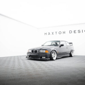 Silver BMW on a circular display in a bright white showroom with Maxton Design branding on the wall behind it.
