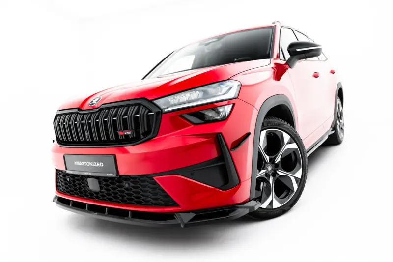 Front-left view of a red SUV showing a bold black grille, angular LED headlights, and large alloy wheels on a white background.