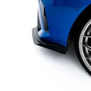 Close-up of a blue car bumper and large alloy wheel with red brake caliper showing through spokes (high-gloss finish).