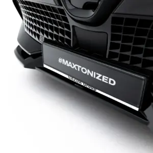 Close-up of a black car's front grille with a license plate reading #MAXTONIZED.