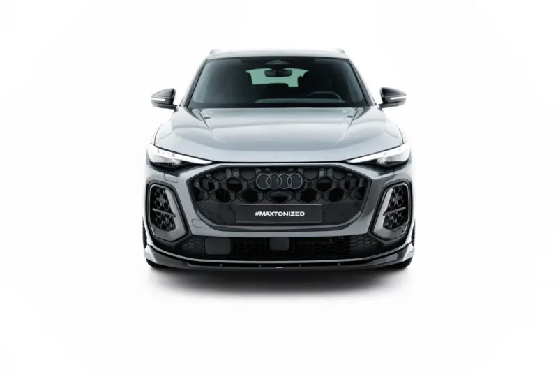Front view of a silver Audi SUV with a bold black honeycomb grille and #MAXTONIZED on the front plate.