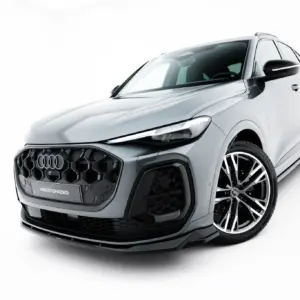 Front-left angle of a silver Audi SUV, showcasing the grille, headlight, and large alloy wheels against a white background with '#MAXTONIZED' on the bumper plate.