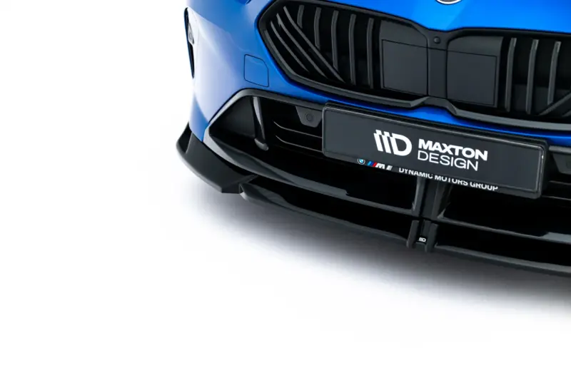 Close-up of a blue car front with a bold black grille and Maxton Design badge on the bumper, highlighting the styling details.