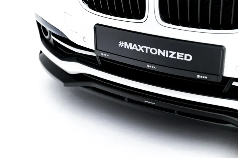 pol_po_Front-Splitter-BMW-3-Sportline-Sedan-Touring-F30-F31-23858_7webp - OPSHOLDERS Close-up of a white BMW front bumper with a black license plate reading '#MAXTONIZED' and BMW branding below.