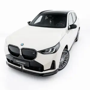 Front-left view of a white BMW SUV with black roof and alloy wheels in a studio setting.