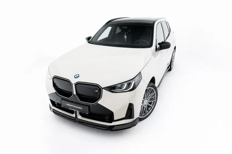 Front-left view of a white BMW SUV with black roof and alloy wheels in a studio setting.