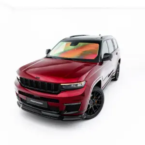 Front three-quarter view of a red Jeep SUV with a black grille and large wheels in a white studio background, angled toward the left.
