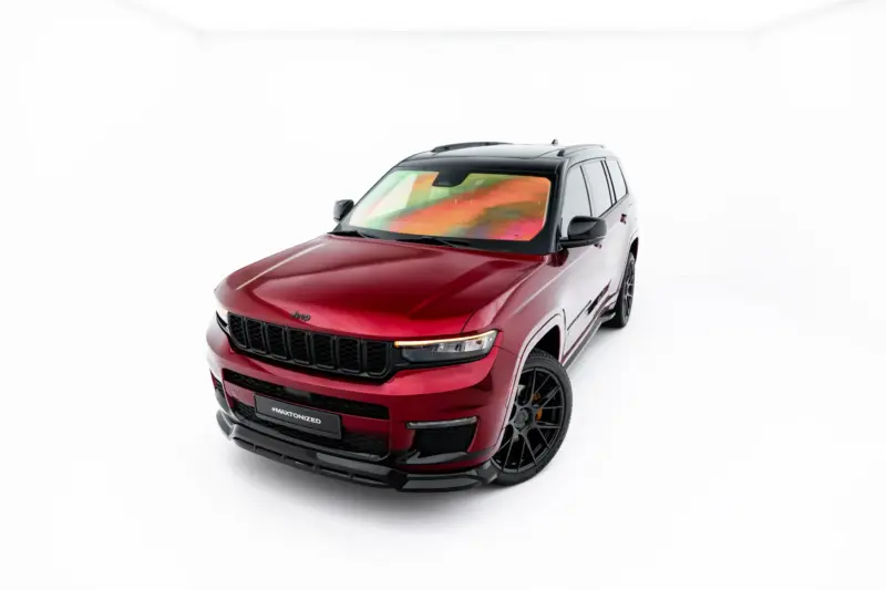 Front three-quarter view of a red Jeep SUV with a black grille and large wheels in a white studio background, angled toward the left.