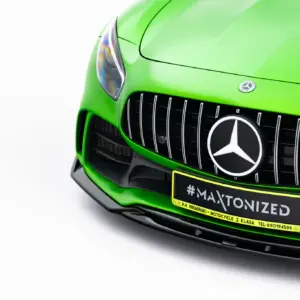 Close-up of a bright green Mercedes front end, with grille and emblem visible and a '#MAXTONIZED' plate in view.