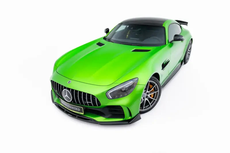 pol_po_Front-Splitter-Mercedes-AMG-GT-R-C190-Facelift-23888_7webp - OPSHOLDERS Bright green Mercedes AMG sports car viewed from front-left, showing grille and sporty wheels.