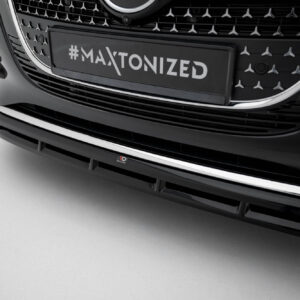Close-up of a car's front grille and bumper with a license plate reading '#MAXTONIZED' in bold white letters on black.