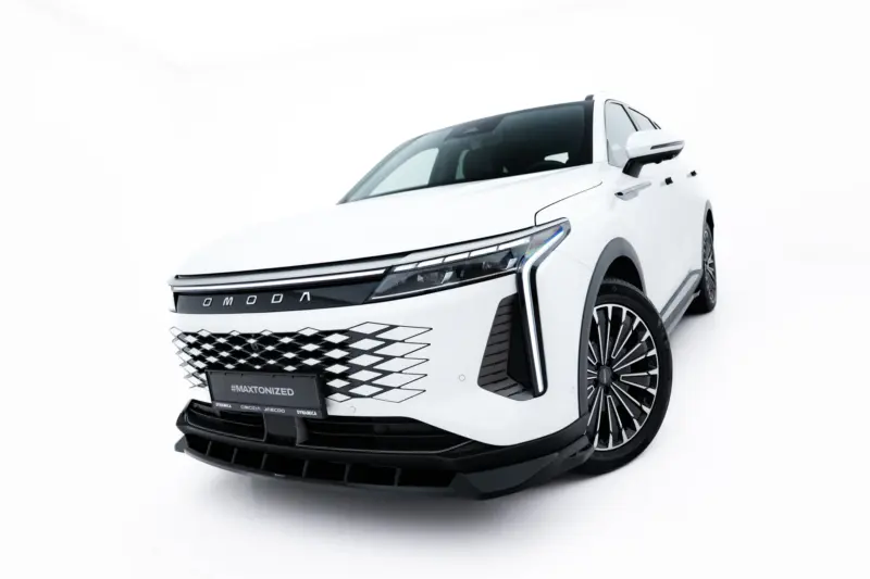 White luxury SUV shown from a low front-left angle, highlighting a bold grille and sleek headlamps, with '#MAXTONIZED' on the license plate area
