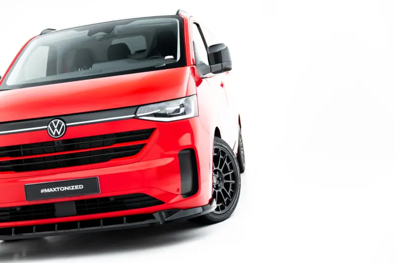 pol_po_Front-Splitter-V-1-Volkswagen-Transporter-T7-23937_5webp - OPSHOLDERS Front-left view of a red Volkswagen van showing the VW emblem, headlight, and bold grille with #MAXTONIZED on the bumper plate.