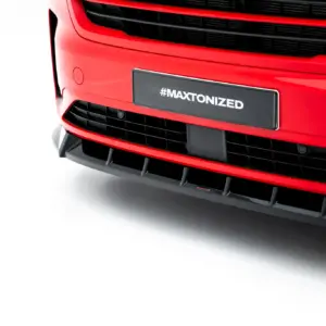 Close-up of a red car front showing a black license plate with the text #MAXTONIZED on the bumper area.