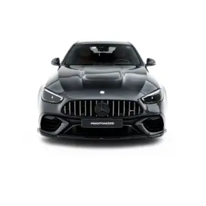 Front view of a dark gray Mercedes-Benz SUV with a prominent vertical-slat grille and sleek headlights, showing the badge and a front hashtag plate reading #MAXTONIZED