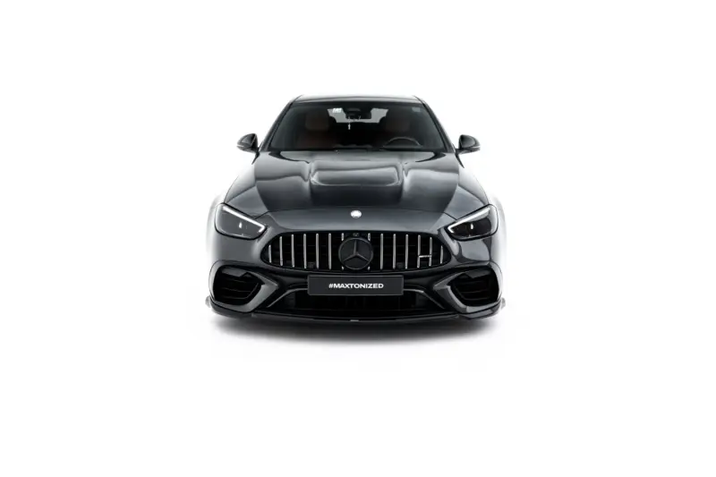 Front view of a dark gray Mercedes-Benz SUV with a prominent vertical-slat grille and sleek headlights, showing the badge and a front hashtag plate reading #MAXTONIZED