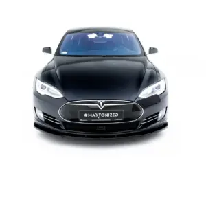 Front view of a black Tesla car facing the camera on a white background, showing headlights and front emblem