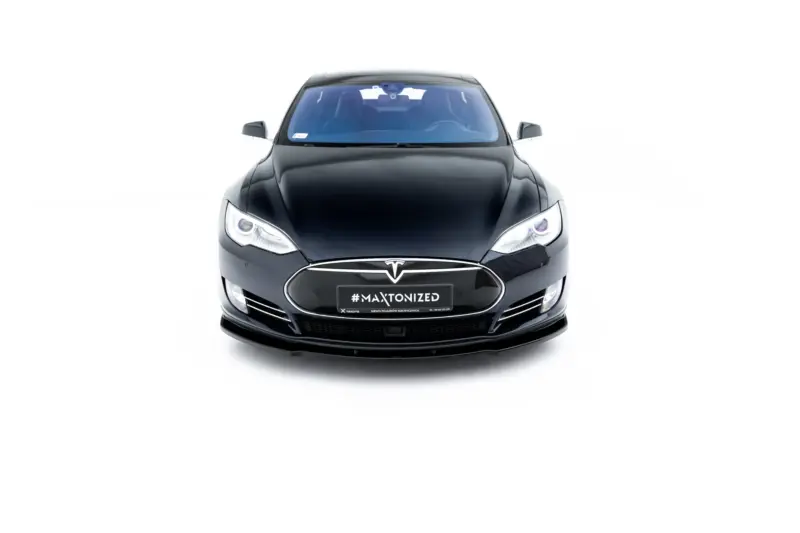 Front view of a black Tesla car facing the camera on a white background, showing headlights and front emblem