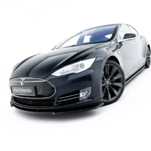Front-left three-quarter view of a dark gray Tesla car with large black wheels on a white background.