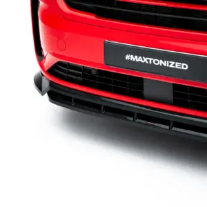 Front of a bright red car showing the grille and a dark license plate that reads #MAXTONIZED (close-up).
