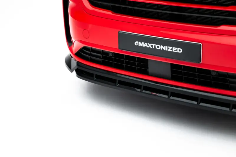 Front of a bright red car showing the grille and a dark license plate that reads #MAXTONIZED (close-up).
