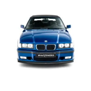 Front view of a blue BMW with a black convertible roof, facing the camera, and a '#MAXTONIZED' plate visible at the grille.