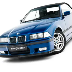 Front three-quarter view of a blue BMW convertible with a black soft top and '#MAKTONIZED' license plate keying its customized look.