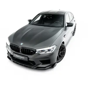 Gray BMW sedan shown from a high front-left angle, highlighting the kidney grille, headlights, and sporty wheels on a white studio backdrop.