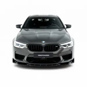 Front view of a gray BMW M5 with a black kidney grille and illuminated LED headlights on a white background, featuring the #MAXTONIZED plate area.