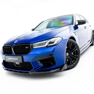 Angled blue BMW sports car facing left, showcasing the bold front grille and headlight design on a white background.