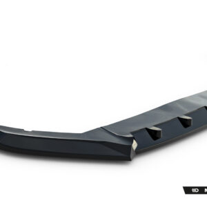 Glossy black curved automotive body part (spoiler/diffuser) laid diagonally on a white studio background with a Maxton Design logo nearby.