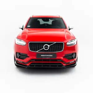 Front view of a bright red Volvo SUV in a studio setting, showing the grille, headlights, and #MAXTONIZED plate on the bumper.