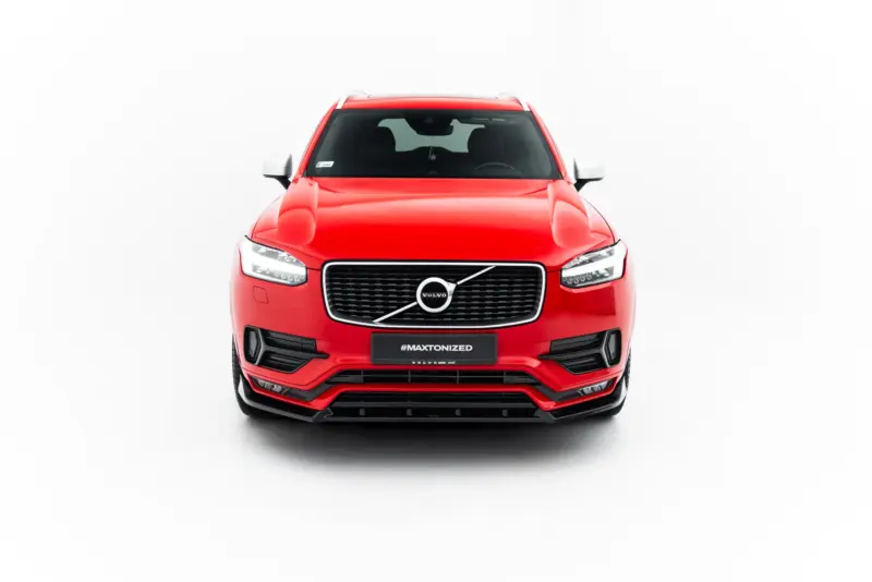Front view of a bright red Volvo SUV in a studio setting, showing the grille, headlights, and #MAXTONIZED plate on the bumper.